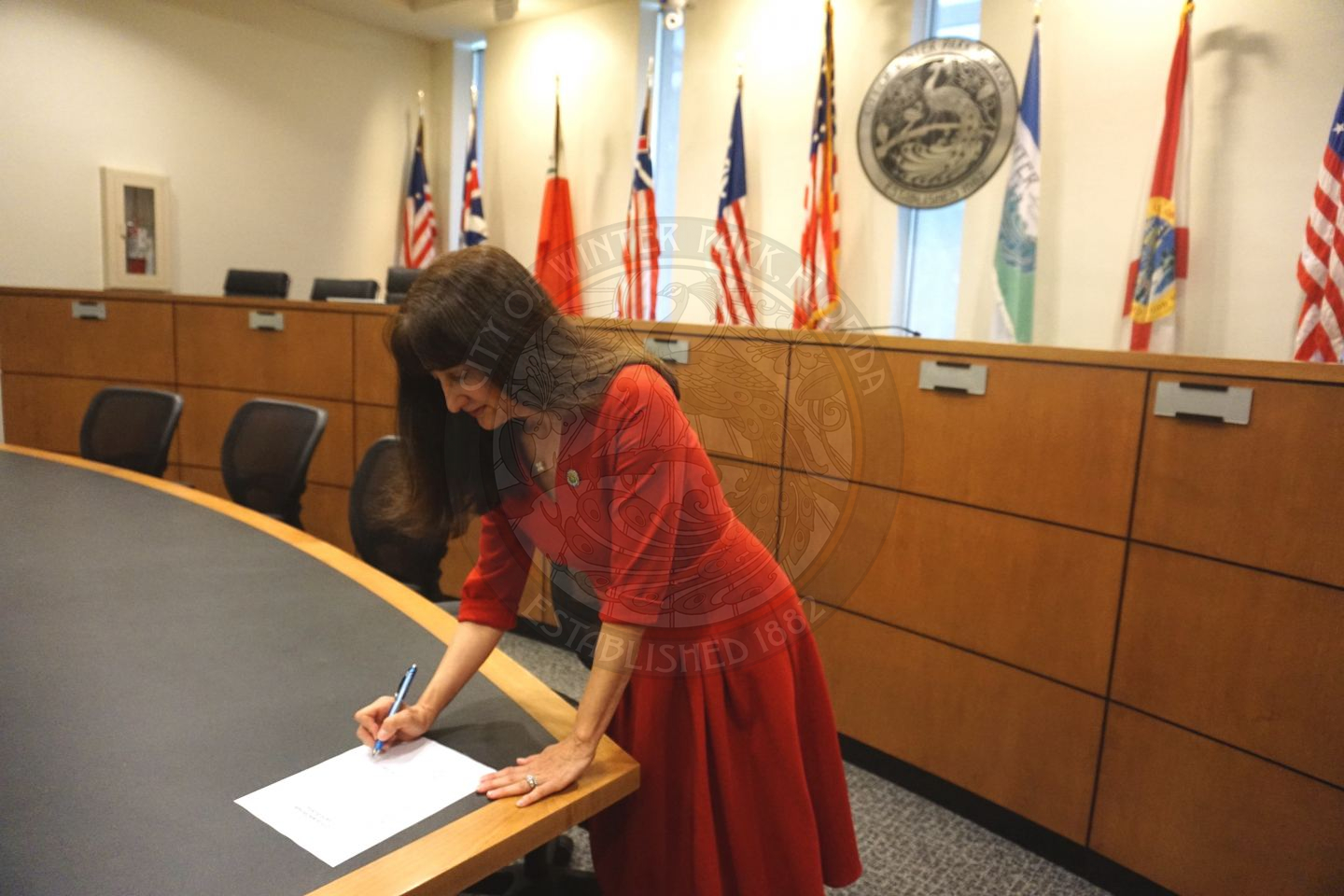 Commissioner Sheila DeCiccio signing official paper