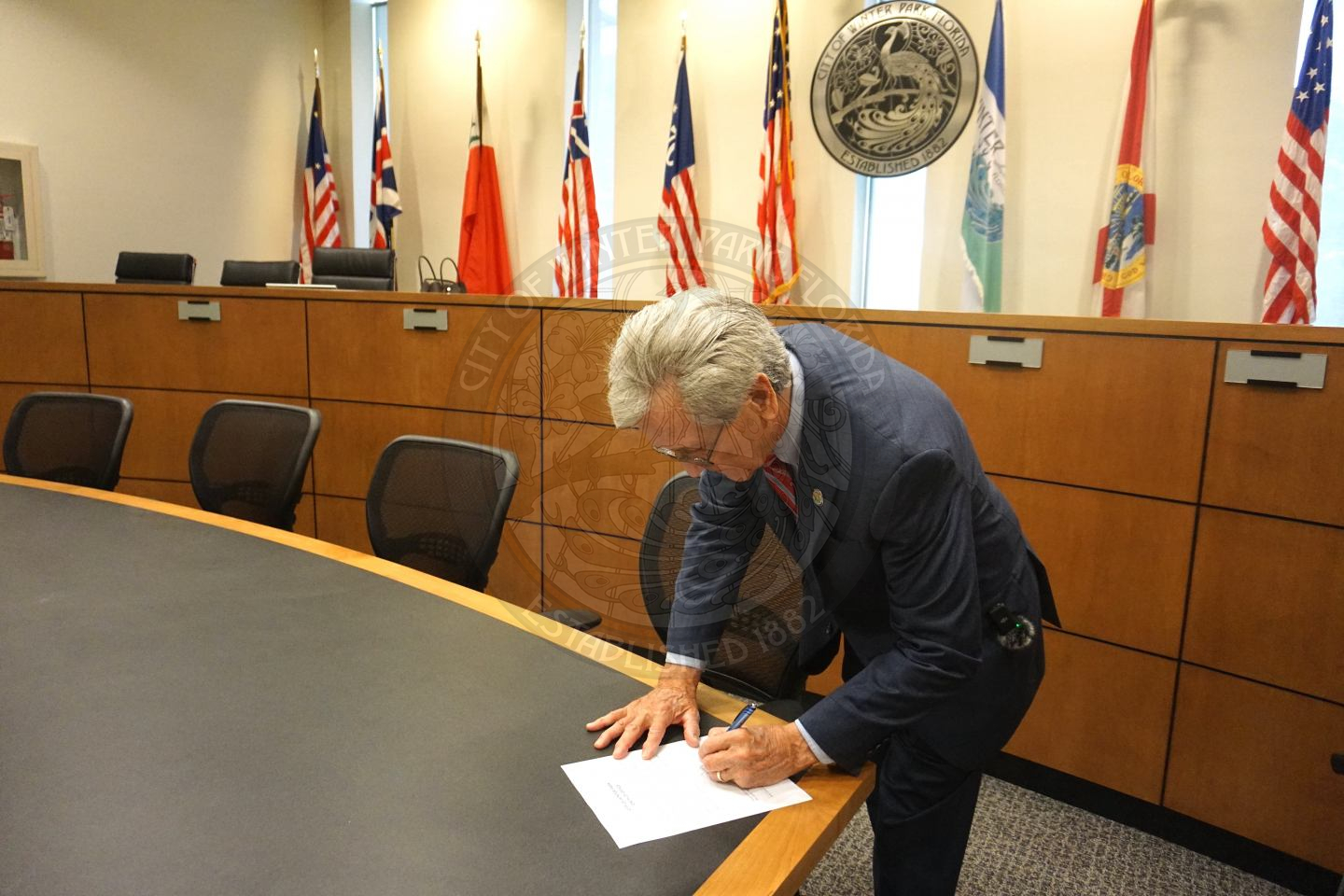 Commissioner Marty Sullivan signing offical paper