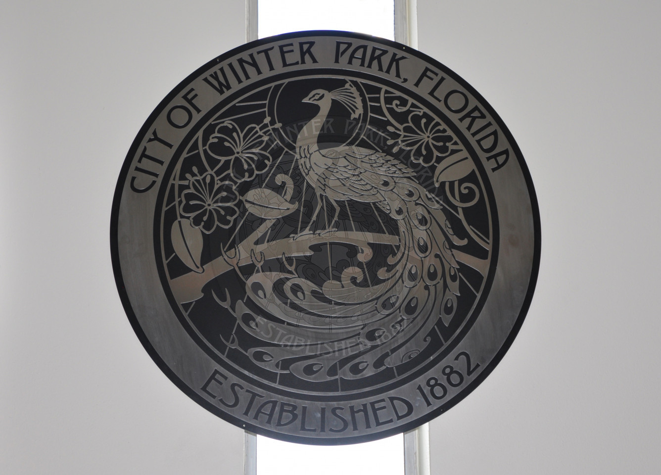 The official city seal that hangs above the dais in Commission Chambers