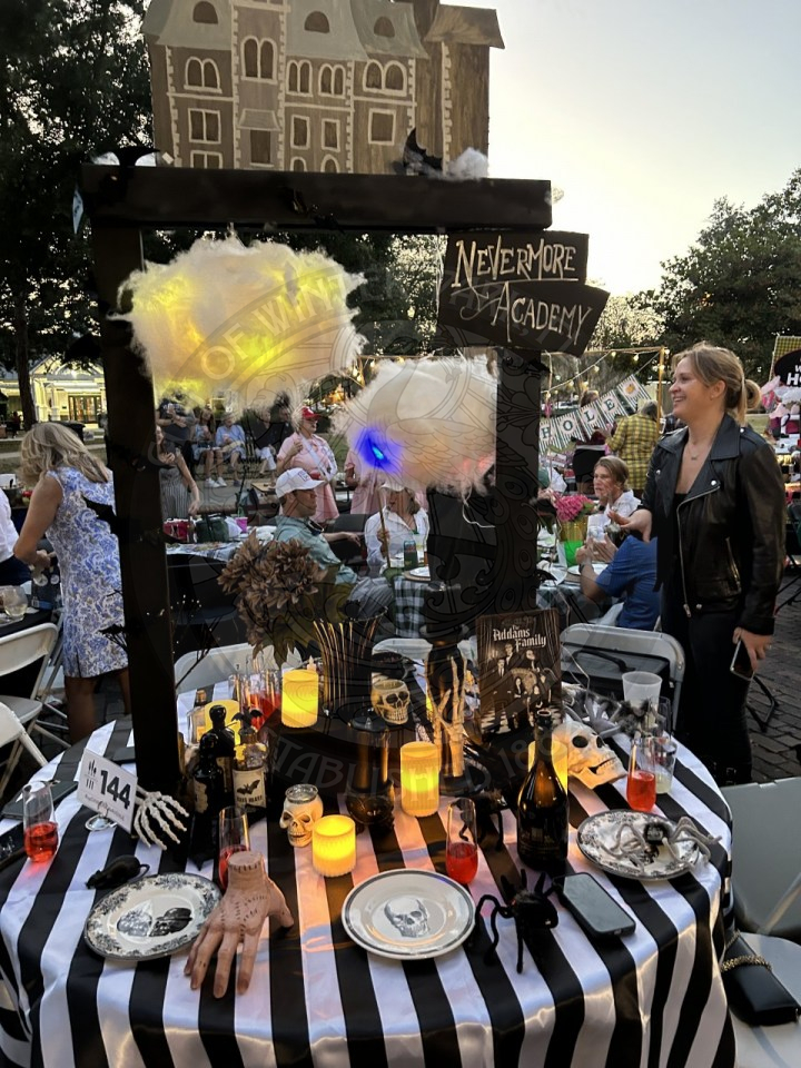 A table decorated for The Addams Family and Nevermore Academy.