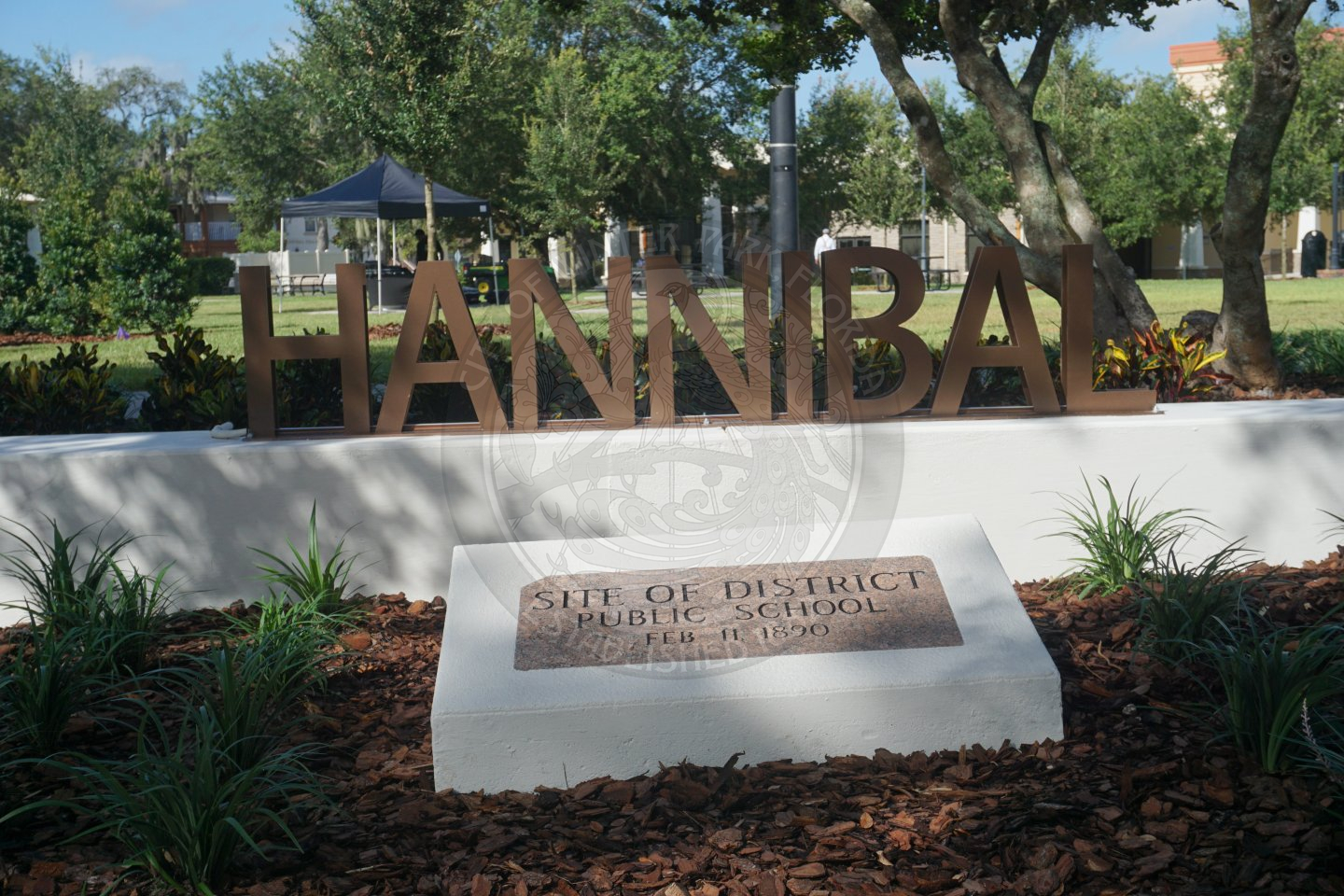 letters that spell out "HANNIBAl" on top of a white bench.