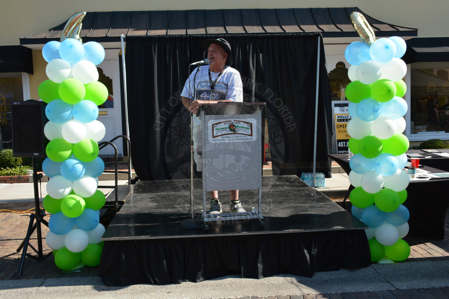 Event Manager Johnny Miller offering announcements at the podium on stage