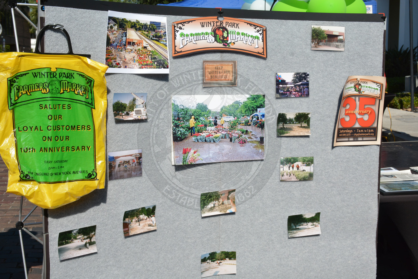Display of Farmers" Market memorabilia including t-shirts, photos, logos and bags