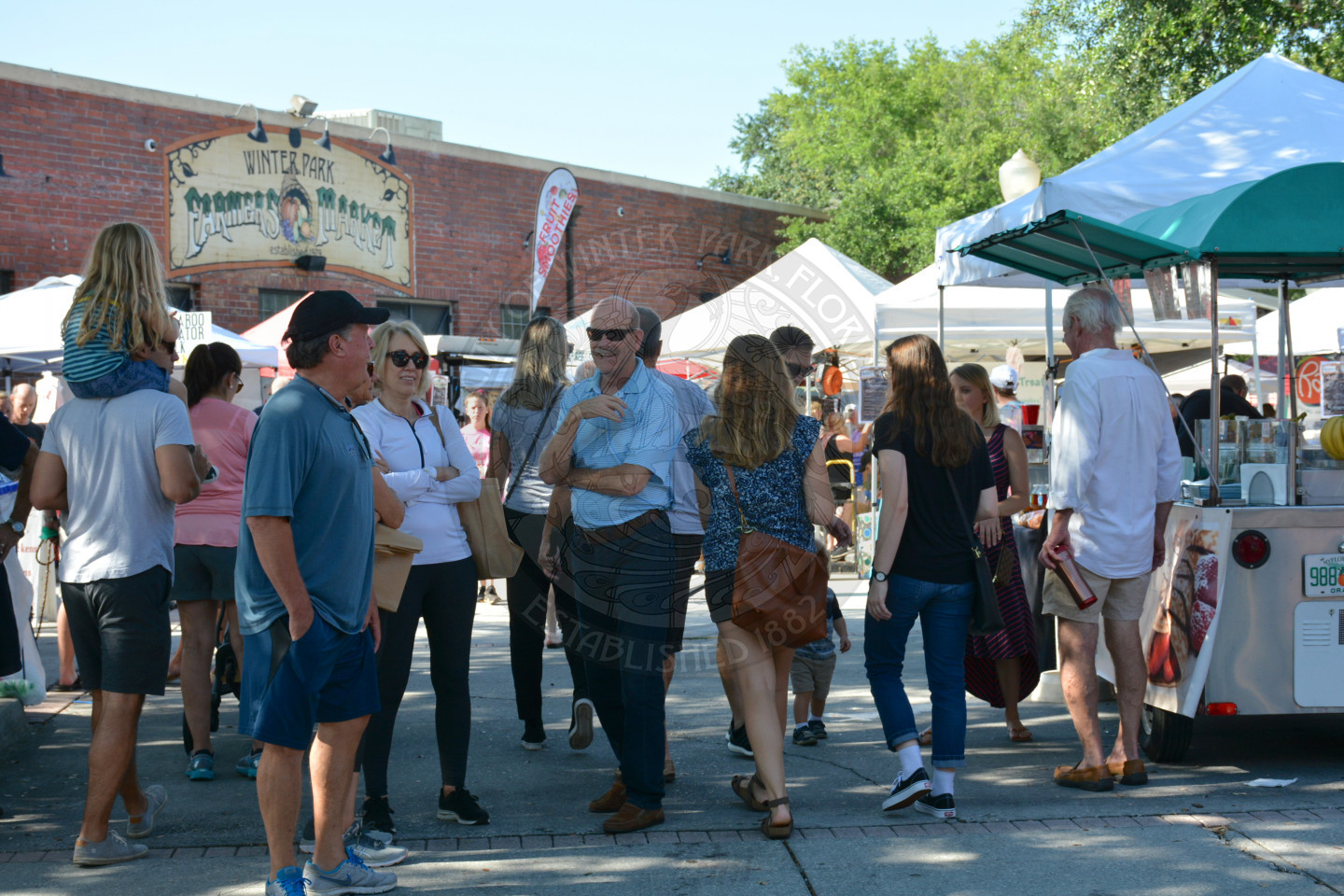Attendees at the event standing and walking around the market