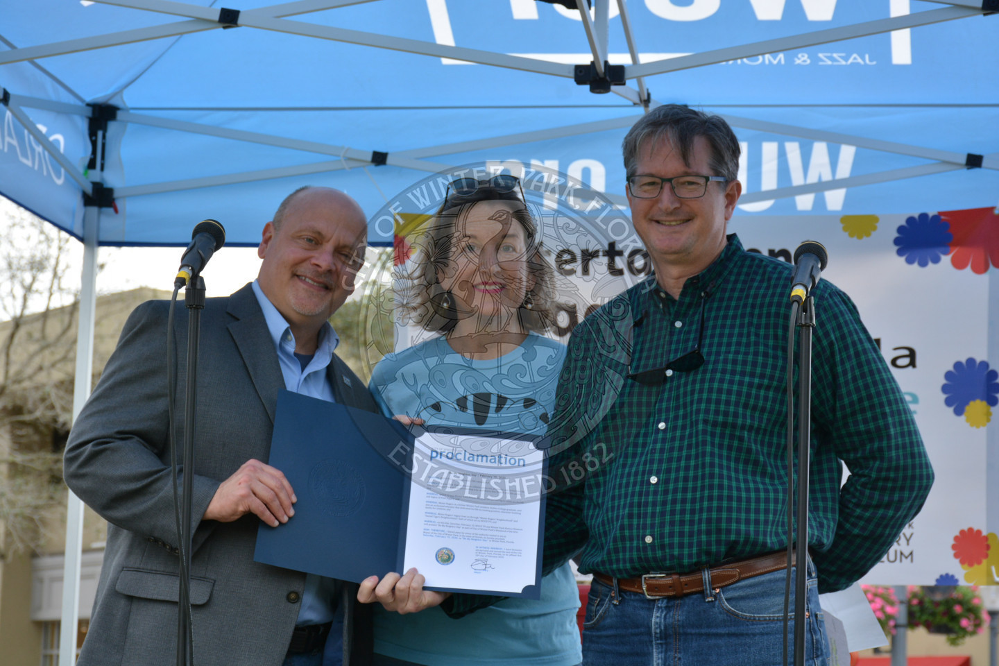 Phil Hoffman, Betsy Owens, and Vice Mayyor Seidel on stage with proclamation