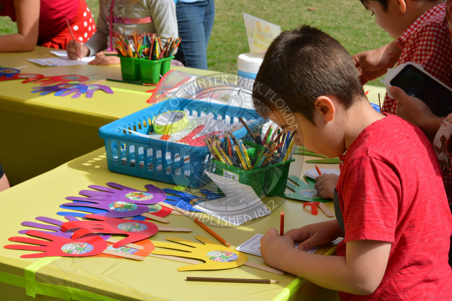 small boy coloring at arts &amp; crafts table