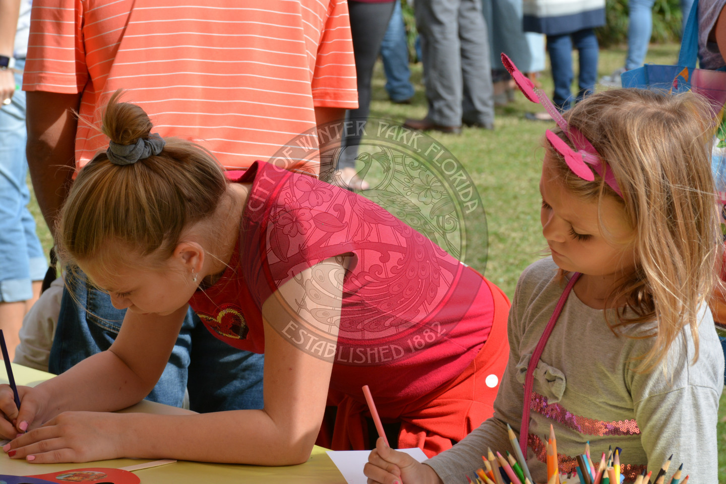 two girls coloring at arts &amp; crafts table