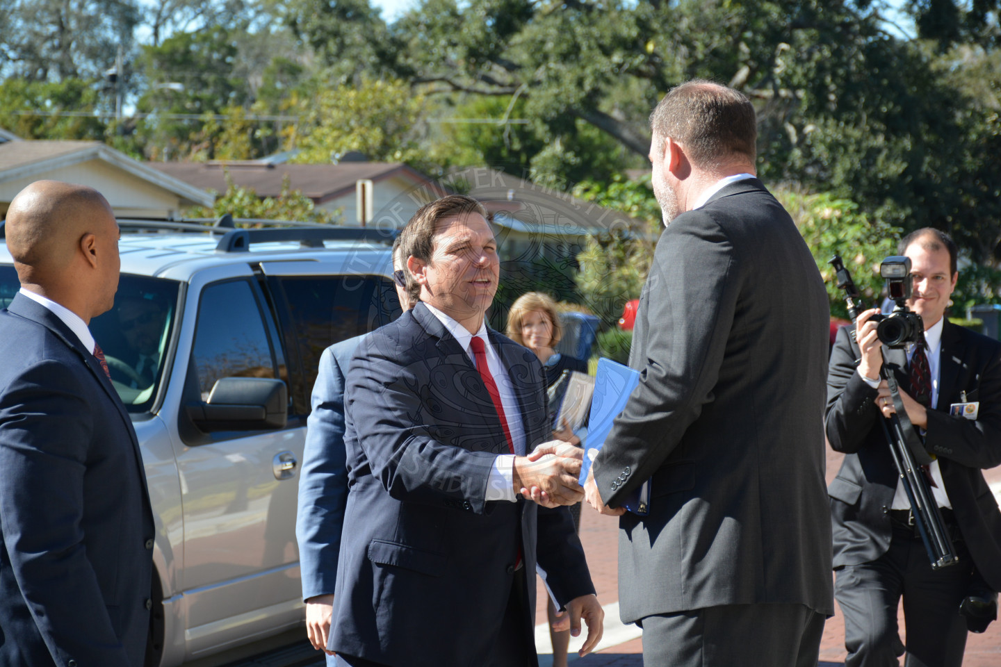 Governor Ron DeSantis exiting vehicle and shaking hands with Mayor Steve Leary