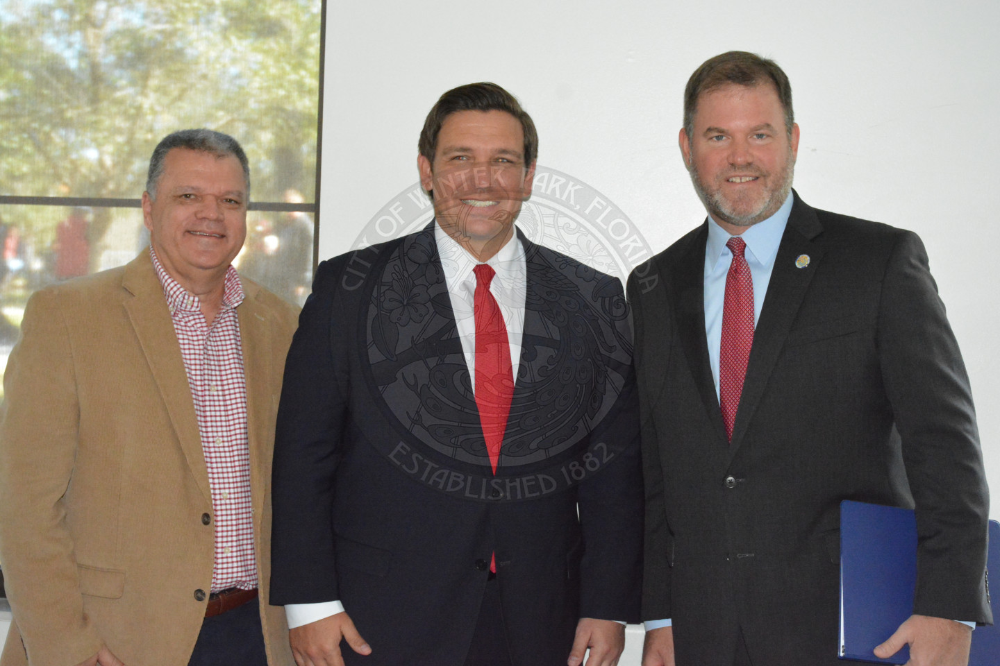 City Manager Randy Knight, Governor Ron DeSantis and Mayor Steve Leary posing for photo
