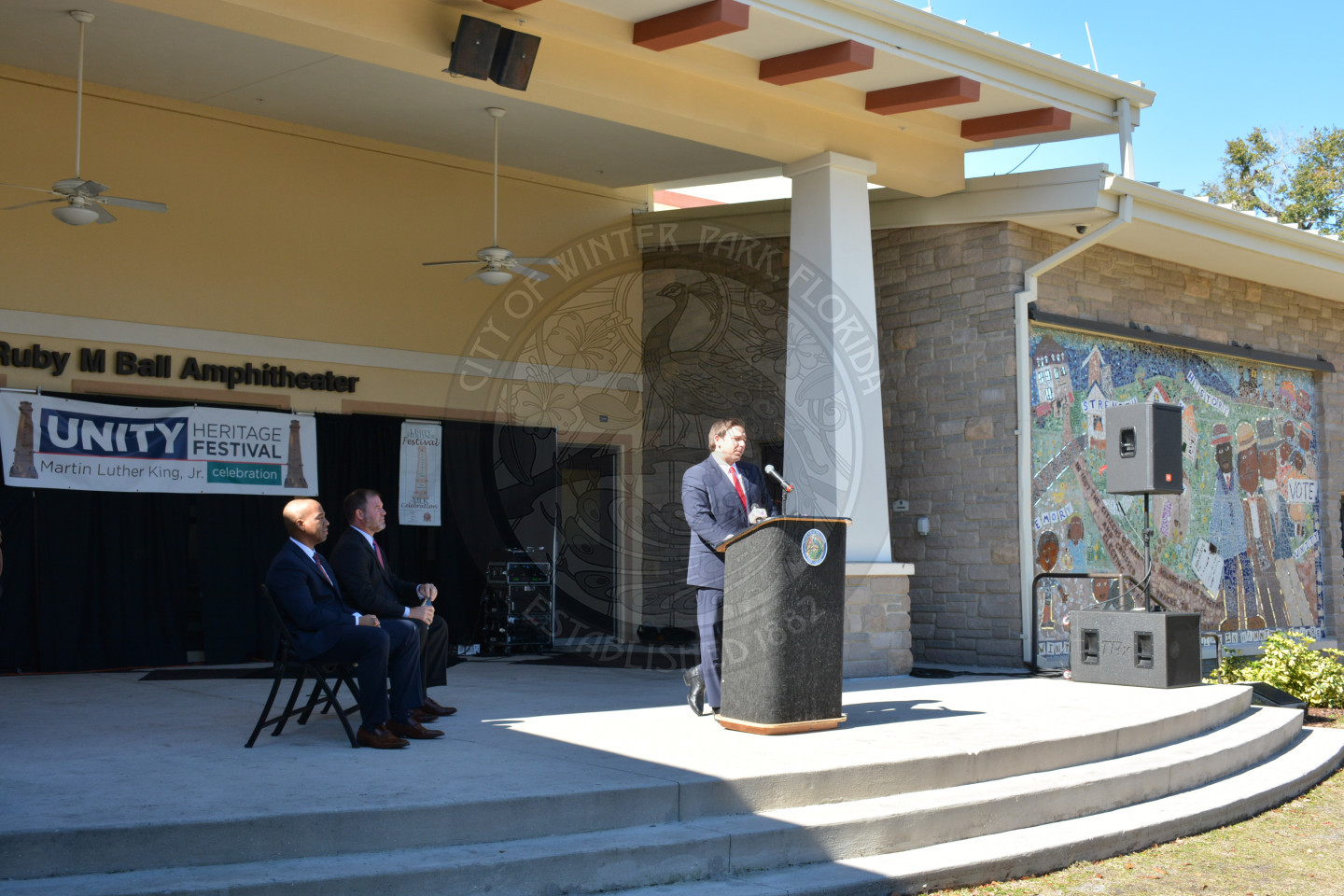 Wide photo of the Ruby Ball Amphitheatre with Governor DeSantis speakign at the podium