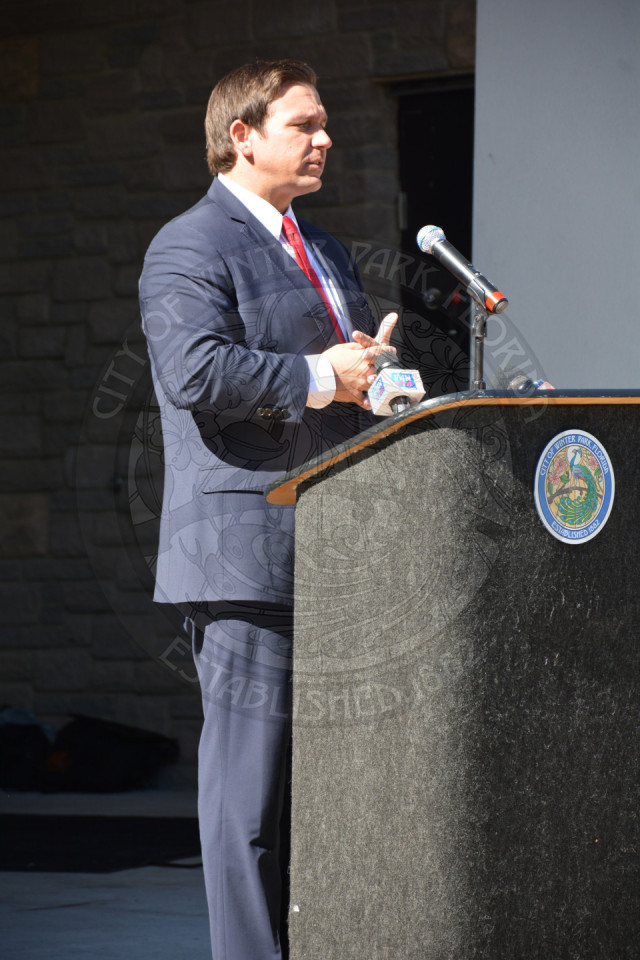 Governor Ron DeSantis speaking at the podium