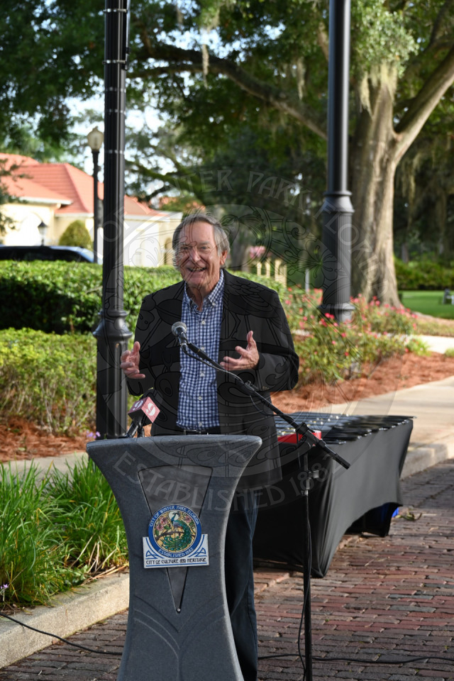 A man standing behind the podium talking into a microphone.