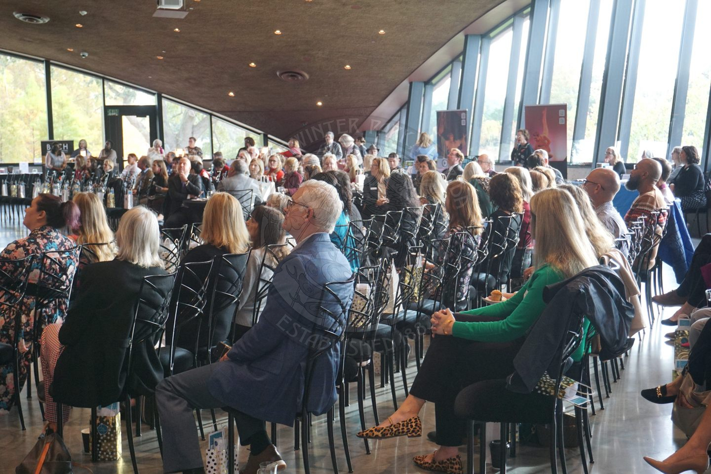 people sitting down watching the speakers.