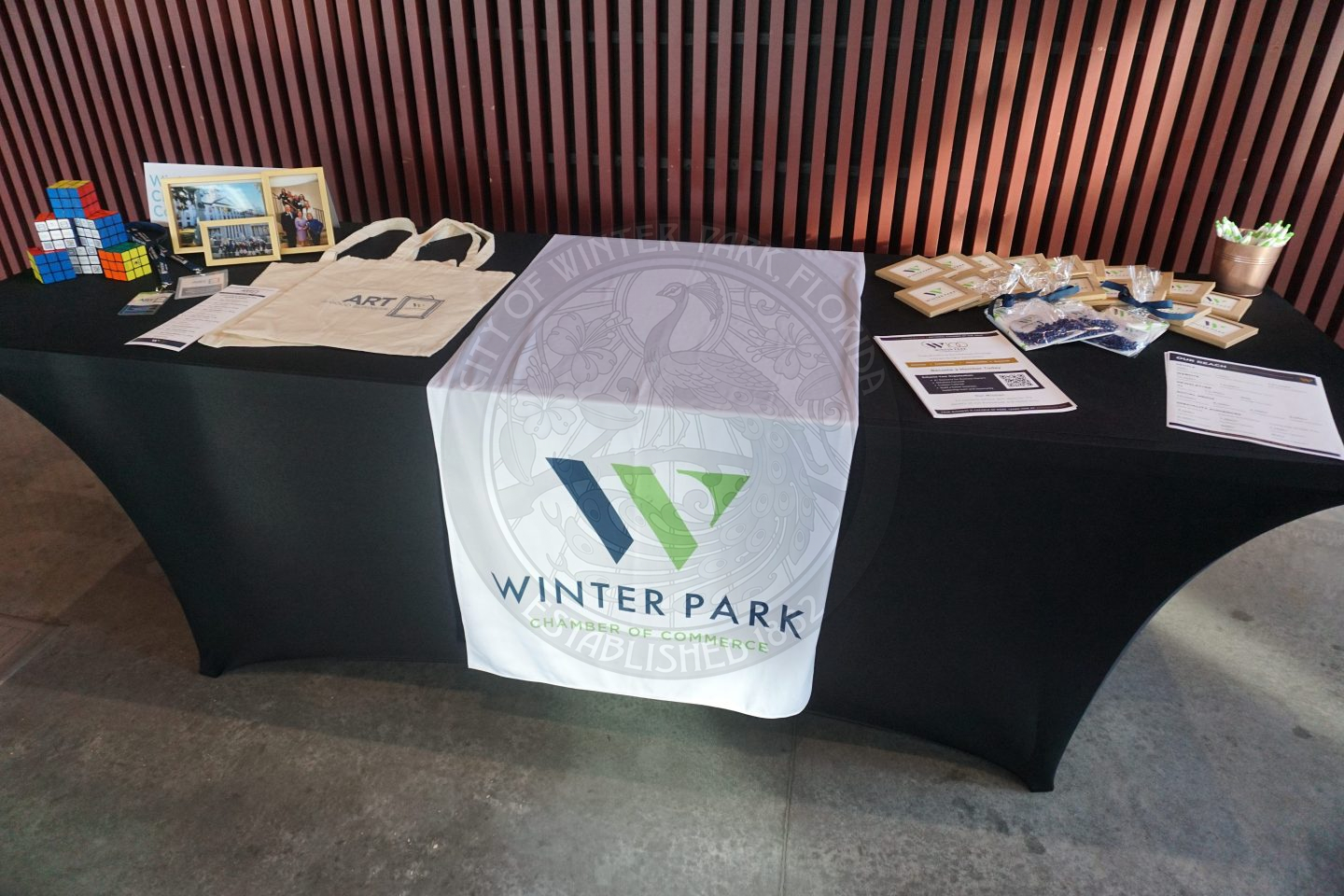 A 6 foot table with information on it about the Winte Park Chambe of Commerce.