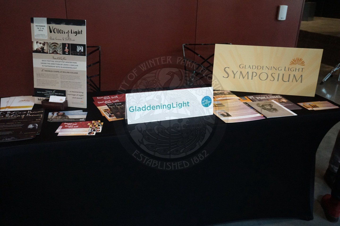 a table with information and pamplets about the company GladdeningLight