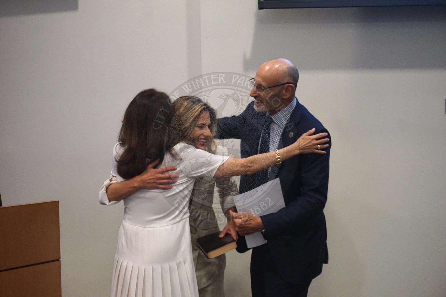 Mayor DeCiccio hugging her daughter and husband after she is sworn into office.