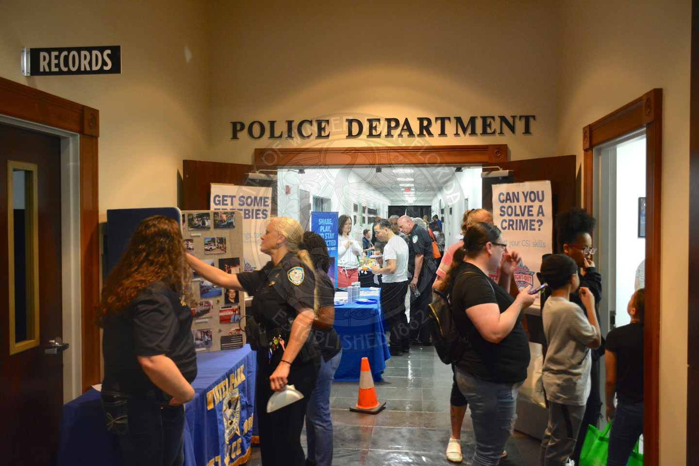 visitors at National Night Out gathered at booths outside of police department offices