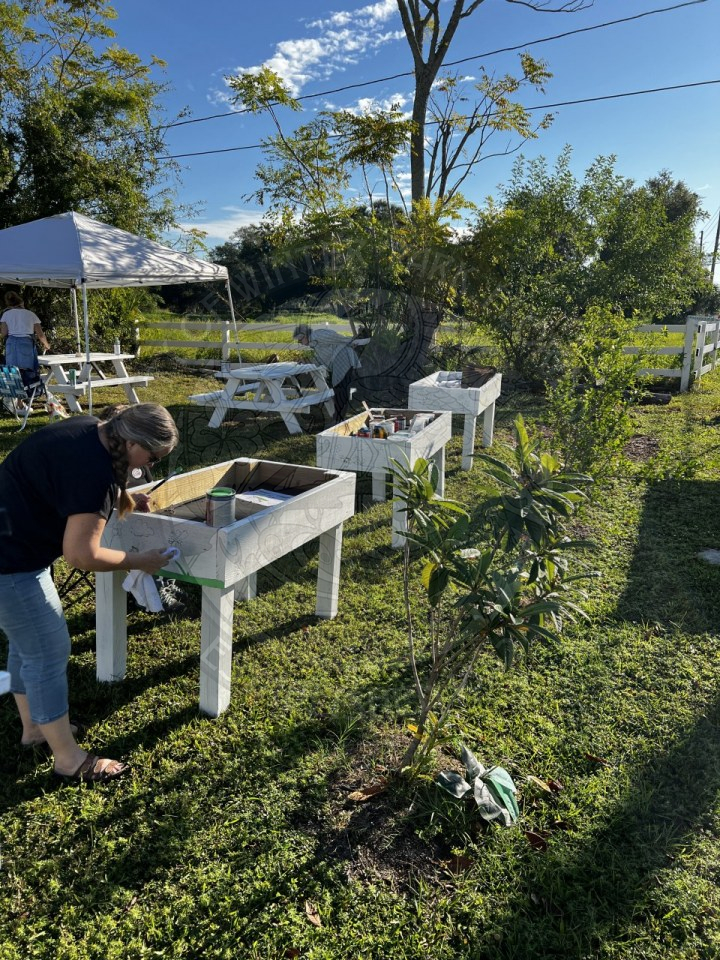 people painting garden nooks and picnic tables