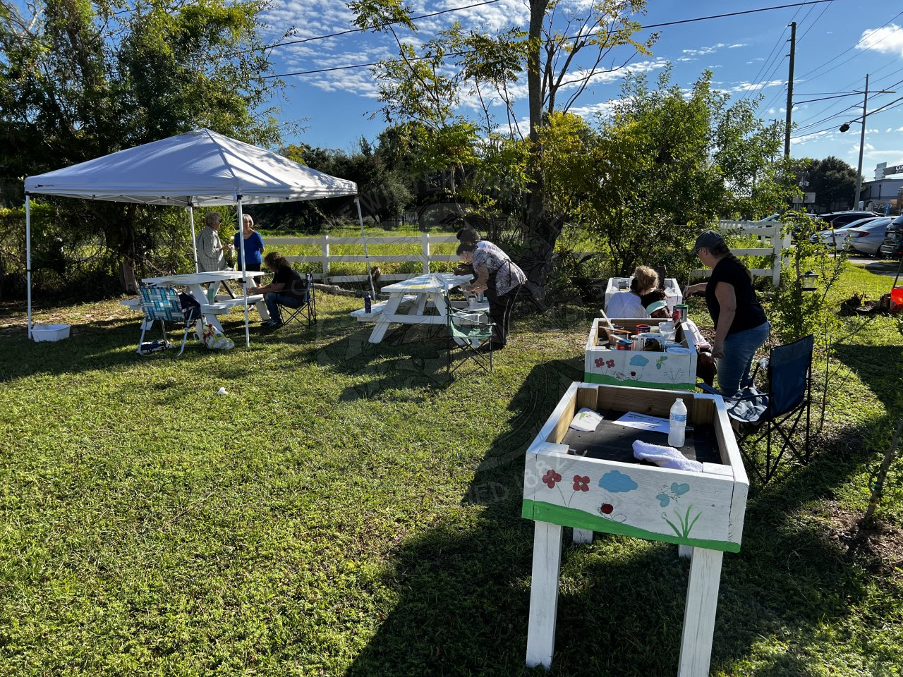 people painting garden nooks and picnic tables