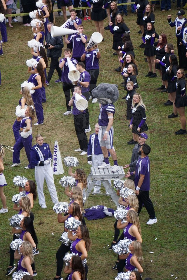 Willie the Mascot standing on the podium where the drum major is supposed to be standing.