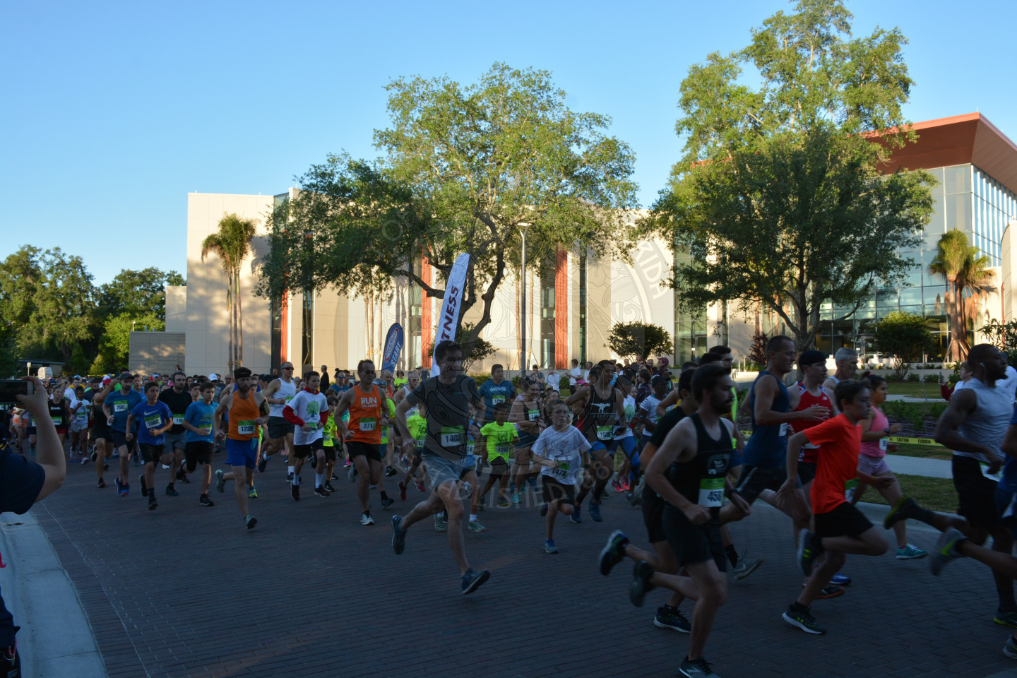 And the race begins - runners starting to run - photo across the start line