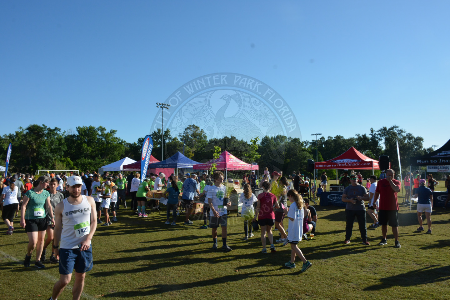 Runners after the race visiting with vendors at their tented booths.