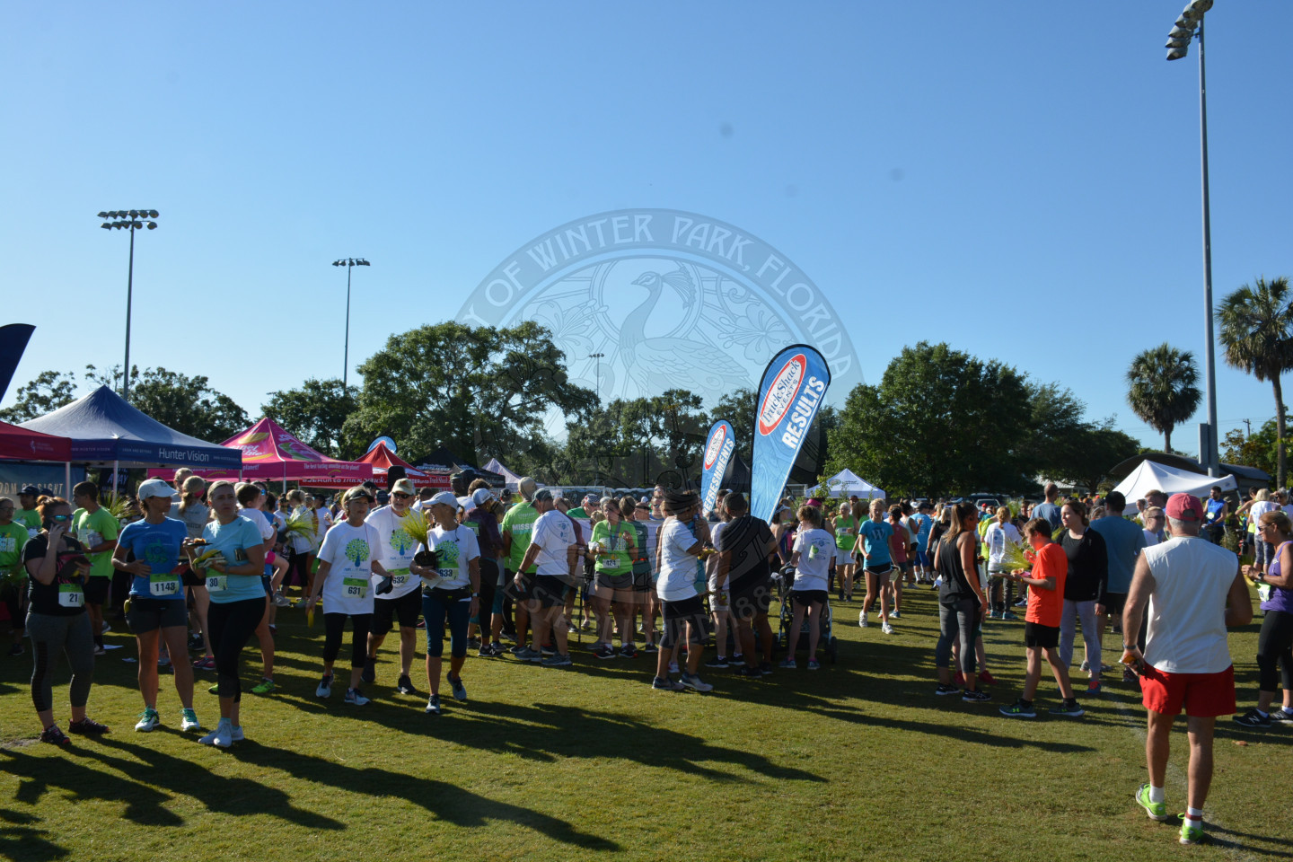 Runners after the race visiting with vendors at their tented booths.