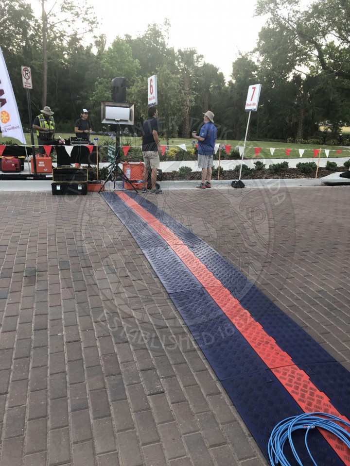 The  finish line painted on the route with black on both sides of a red line.