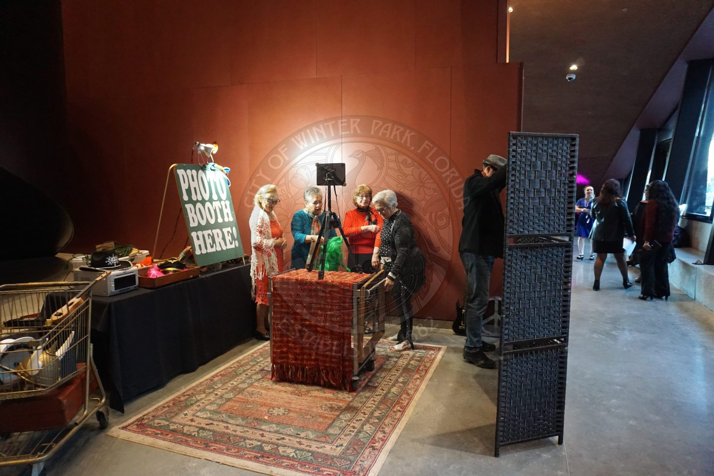 4 women setting up the photo booth area.