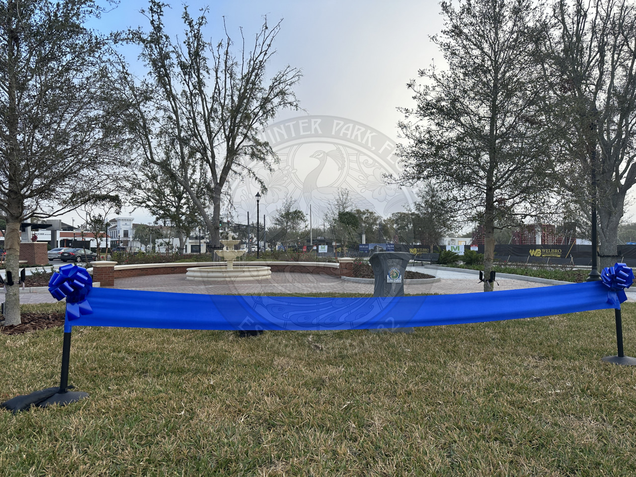 A blue ribbon tied to two poles to make a ribbon cutting.