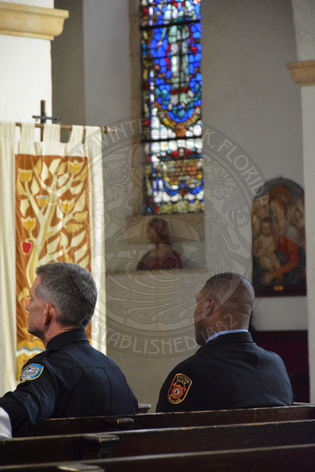 Two gentlemen seated in pews
