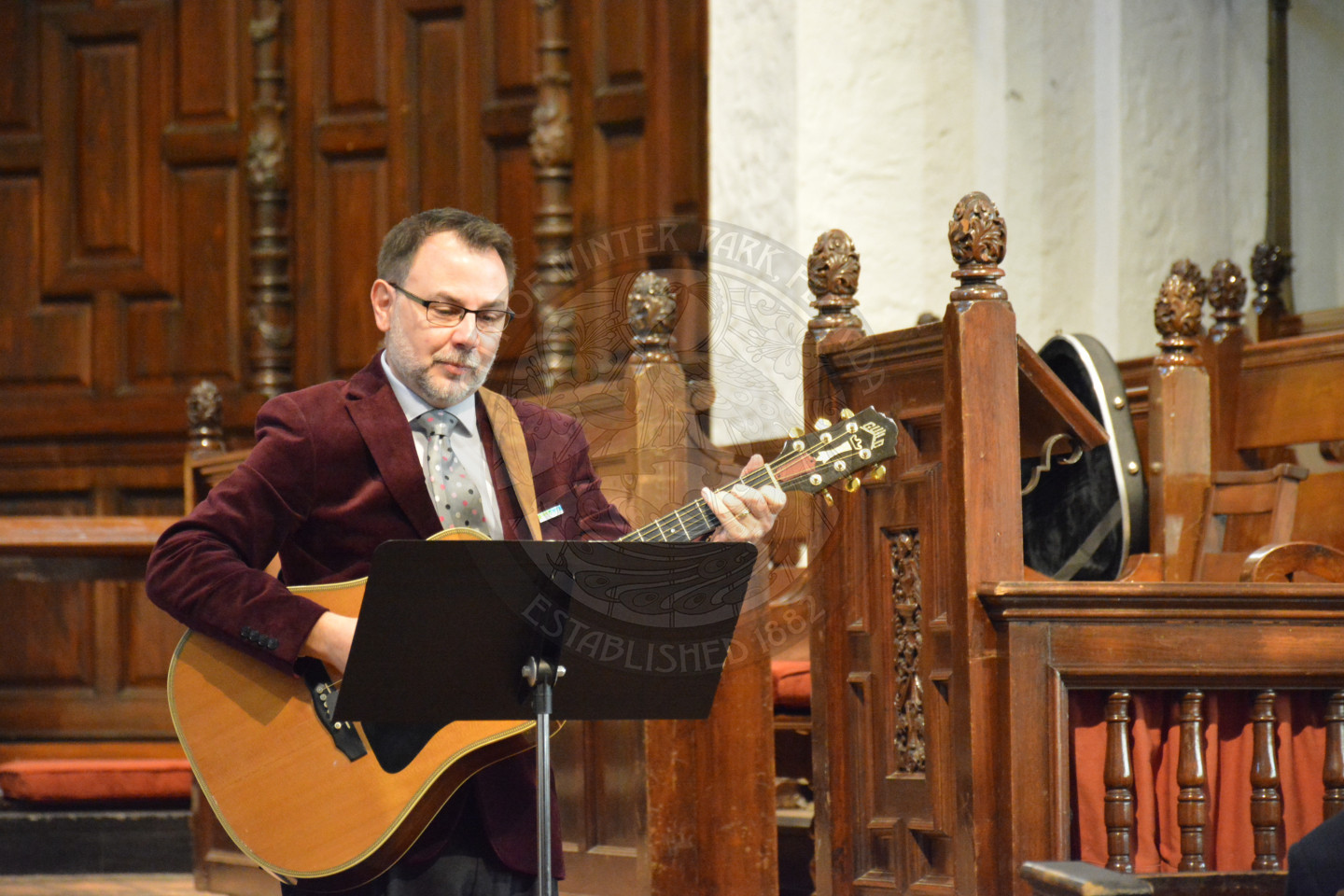 Reverend Shawn Garvey playing the guitar and signing a musical tribute
