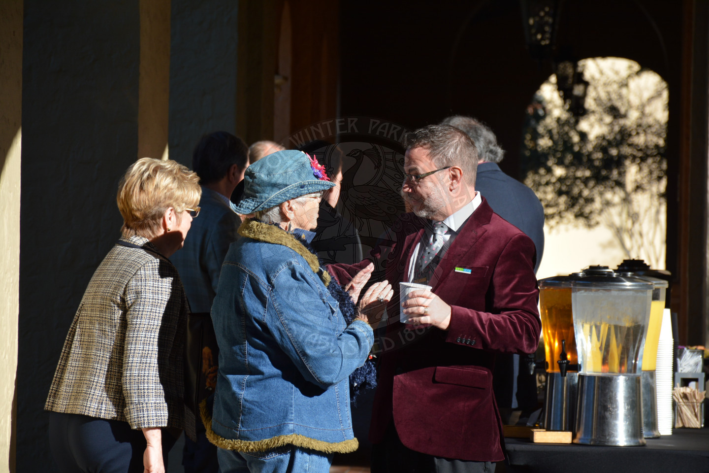 Reverend Shawn Garvey speaks with two female attendees after the event