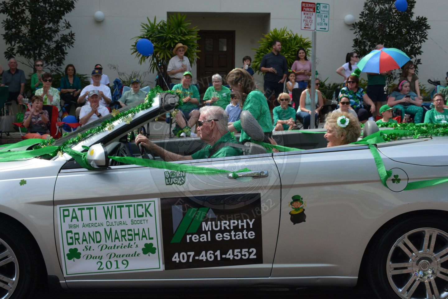 Photo of white convertible with Grand Marshal of the parade in the car