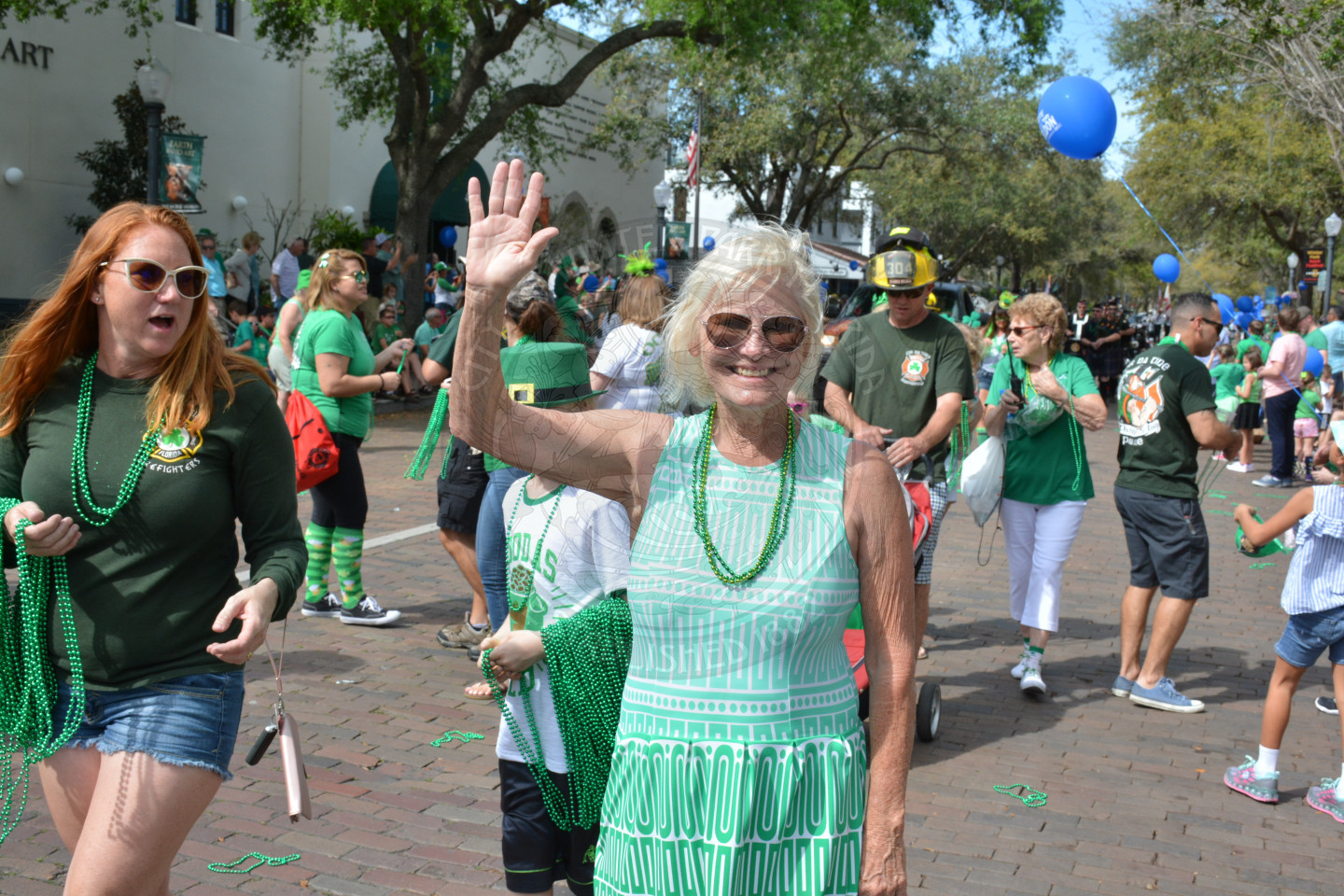 Commissioner Sarah Sprinkel and parade participants waving