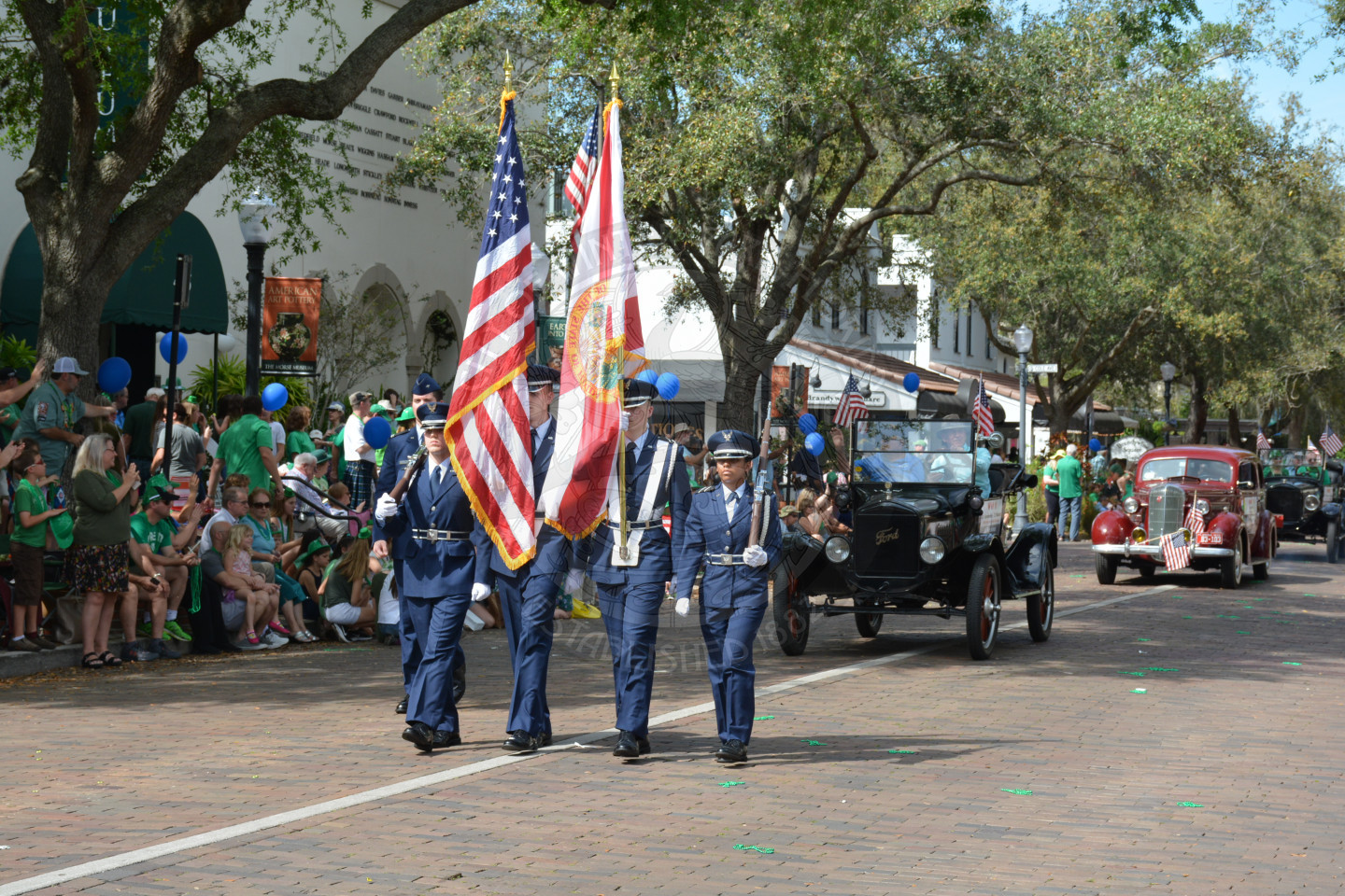 Cadets travelling down parade route holding American and State Flags