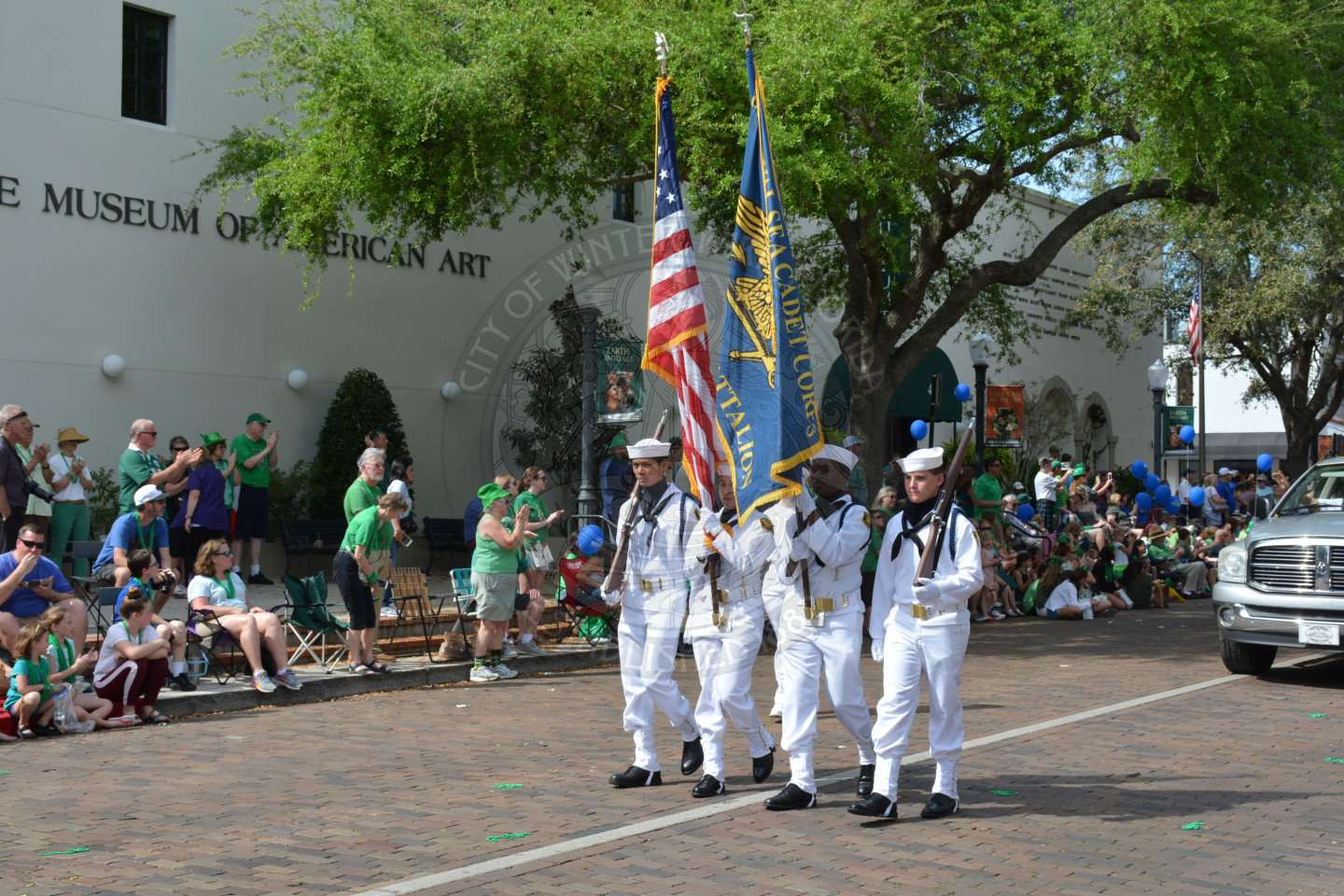Naval Sea cadet corps holds American Flag and Navy Flag down parade route
