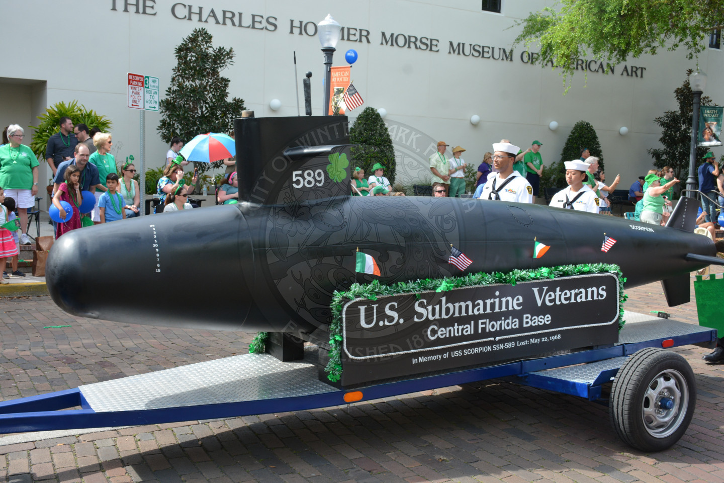 United States Submarine Veterans float of small submarine and people walking beside it