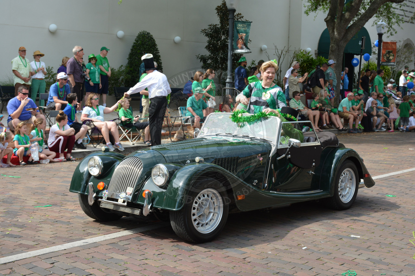 City Commissioner Carolyn Cooper seated in convertible car greeting the crowds