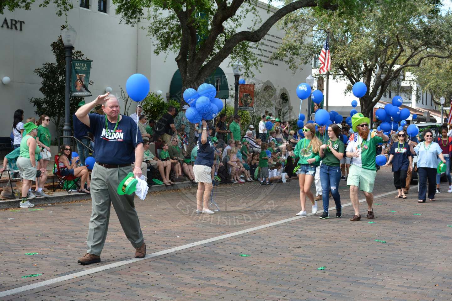 Commissioner Pete Weldon waves to the crowds along the parade route.