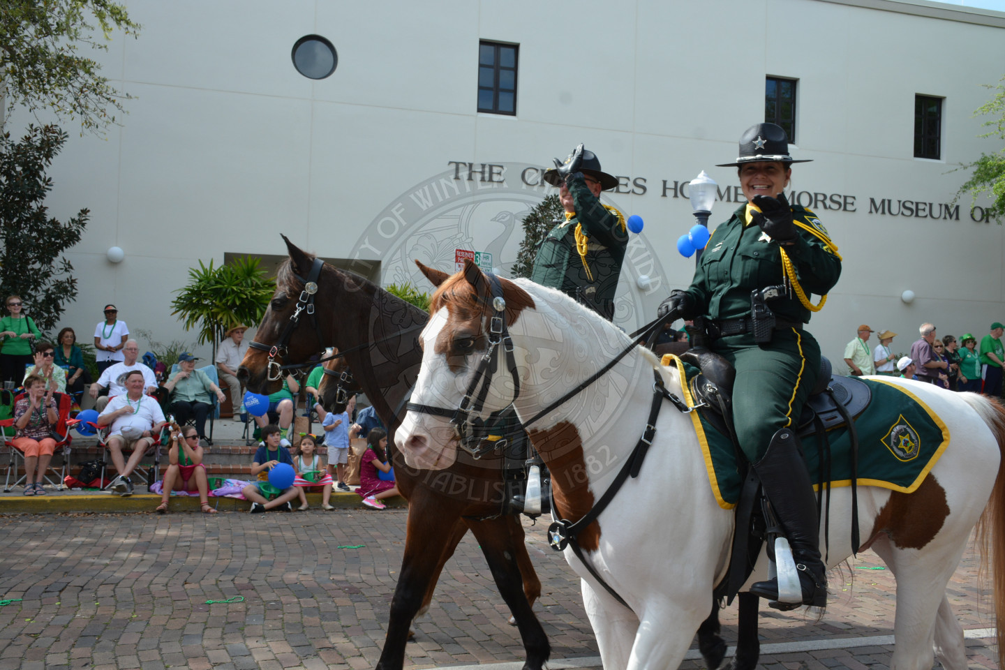 Two Orange County Mounted Patrol officers and hoses