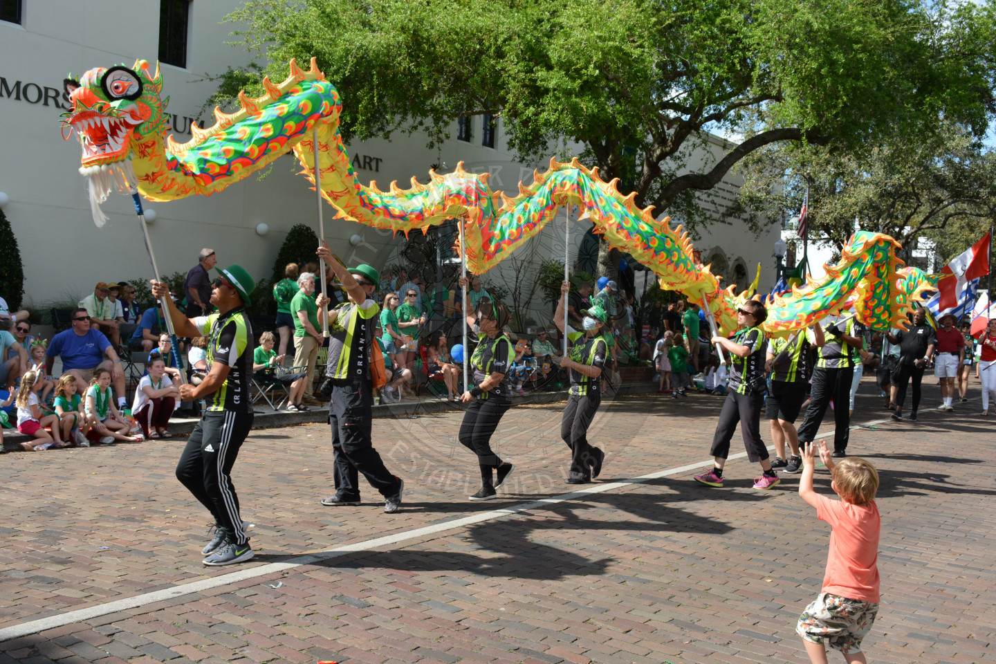 Colorful dragon on sticks held above the heads of parade participants