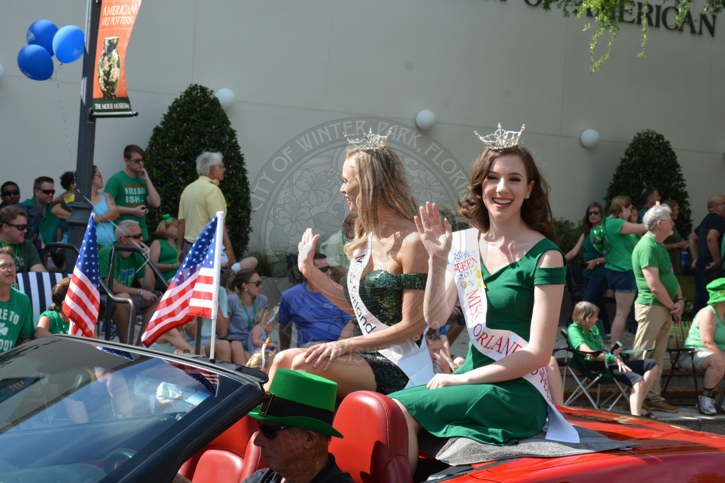 Miss Teen Orlando and Miss Orlando sitting in convertible vehicle waving
