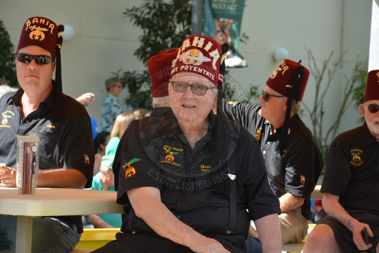 Gentleman wearing a hat with the word Bahia on the front of the hat, surrounded by other gentlemen on a float