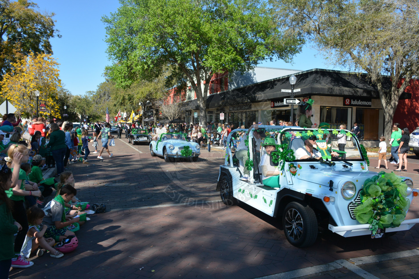 old fashioned cars driving through the parade