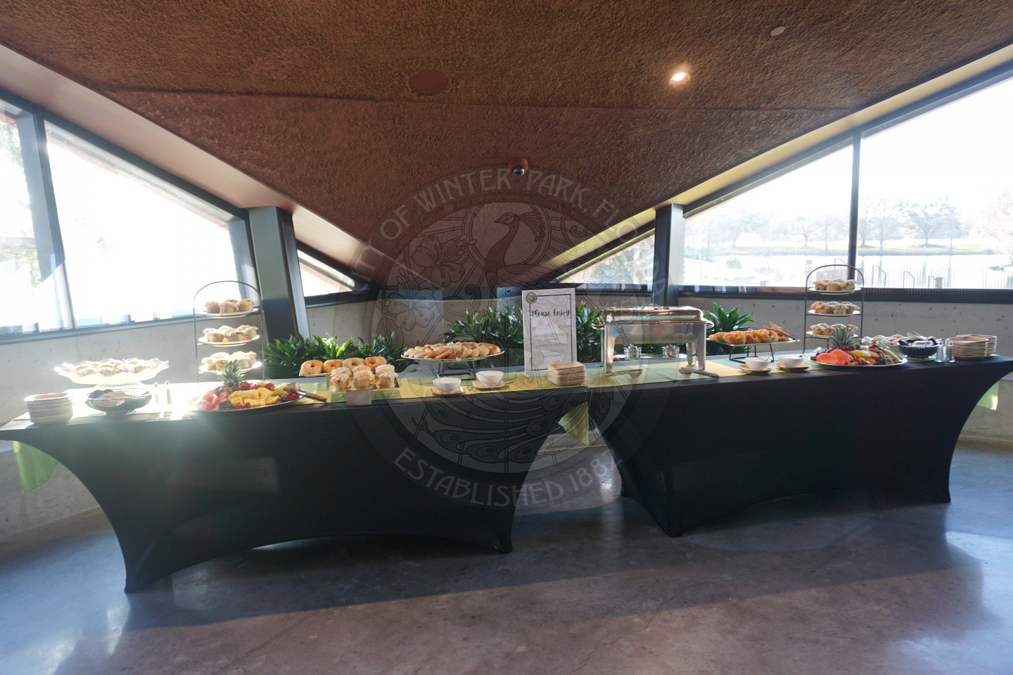 Picture of 2 tables with bagels, fruit, muffins, and egg fritattas