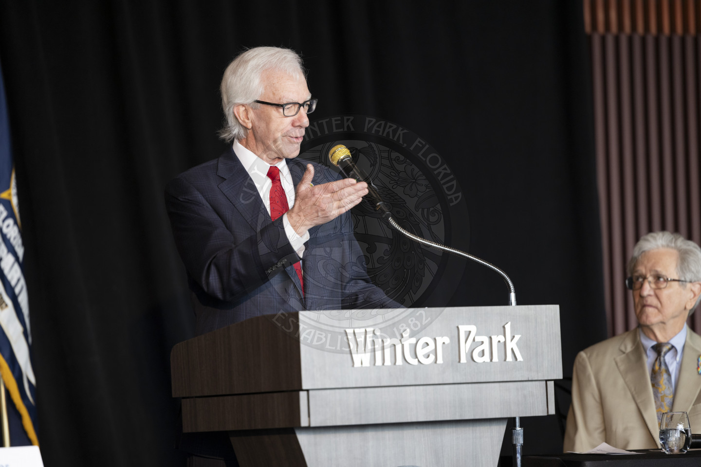 Mayor Phil Anderson talking to into a mircophone and presenting his state of the city.