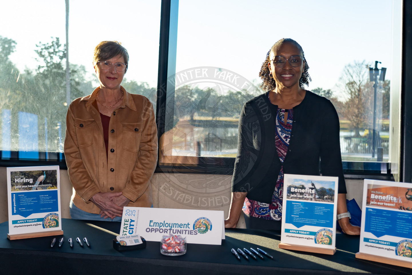 two females standing behind a table with informaiton about employment opportunities at the City of Winter Park