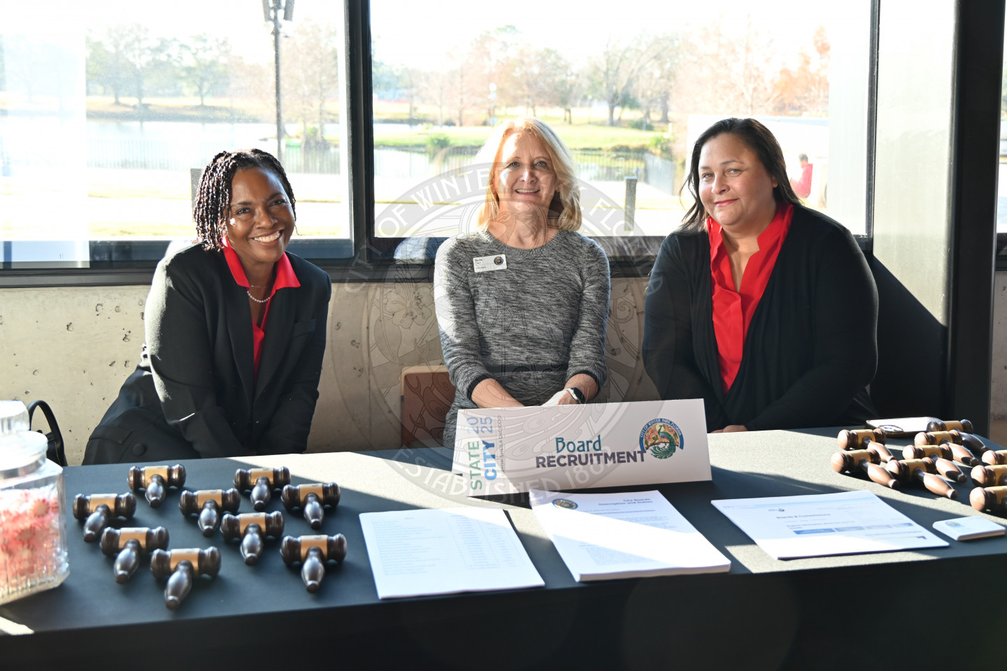 three ladies sitting behind a table for board recruitment