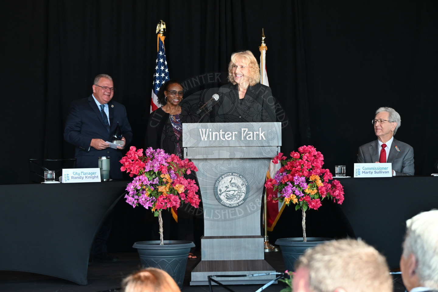 Employee of the Year, Jeanni Ruddy standing behind the podium 